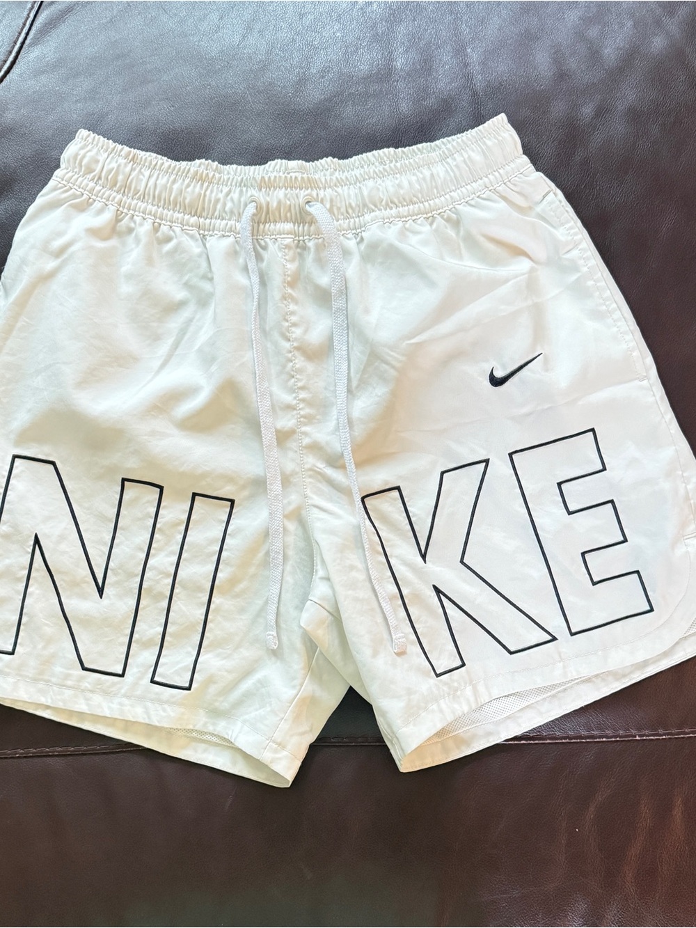 Nike Men’s White Athletic Shorts with Black Logo Outline